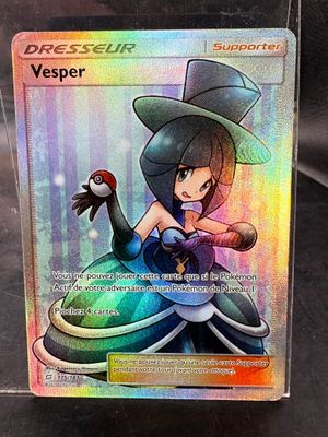 the card is in a clear plastic box on a black surface