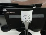 a lot of computer monitors sitting on a table