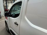 a white van that is parked in a parking lot