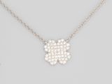 a diamond flower pendant on a chain