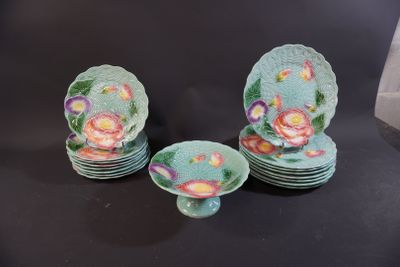 several plates and bowls are sitting on a black surface