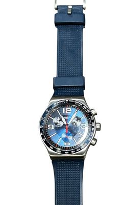 a close up of a watch on a white background with a blue strap