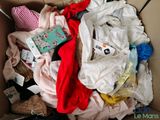 a cardboard box filled with clothes and other items