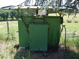 a green box sitting in the middle of a field