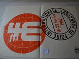 two posters on a bed with a red and white design