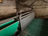 a large machine that is working on a green floor