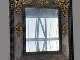 a picture of a mirror that is hanging on the wall