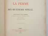 an open book on a white surface with a red and black title
