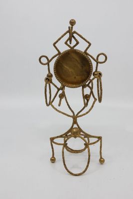 an image of a brass candle holder on a white background
