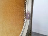 an upholstered chair with a gold velvet upholstered seat