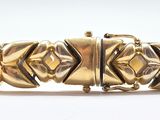 an image of a gold bracelet on a white background