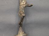 an antique bronze figurine of a woman on a skateboard