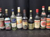 many different types of alcohol bottles lined up on a table