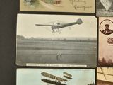 several old photos of airplanes are displayed on a black surface
