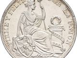 a close up of a coin with a woman sitting on a chair