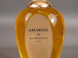 an image of a bottle of perfume with a white feather on top