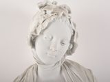 a white statue of a woman with a head scarf