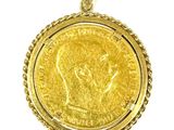 a close up of a gold coin pendant on a white background