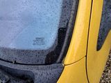 a yellow car that is parked on the side of the road