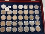 a box of coins sitting on a table next to a box of coins