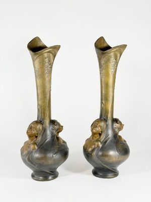 two vases that are sitting side by side on a white surface