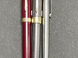 two pens sitting next to each other on a table
