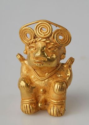 gold figurine of a monkey with a crown on its head