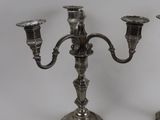 pair of antique silver plated candlesticks on a white background