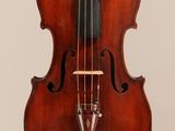 an old violin with a bow hanging from it ' s back
