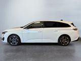 the white car is parked in a large room with a white wall