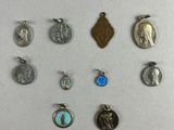 a close up of a bunch of different charms on a white surface