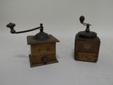 pair of antique wooden coffee grinders on a white background