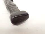 a close up of a black and white baseball bat on a white surface