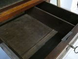 a wooden drawer with a book inside of it