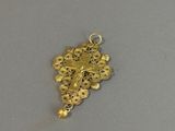 a close up of a gold pendant with a cross on it