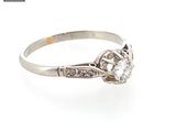 a close up of a diamond ring on a white background