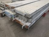 several steel beams are stacked on top of each other in a warehouse