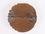 a small metal object that is on a white surface