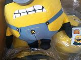 a small stuffed toy in a box with a tag on it