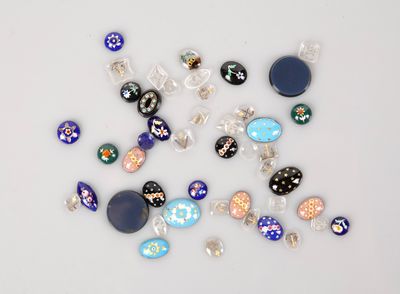 a lot of different colored stones and beads on a table