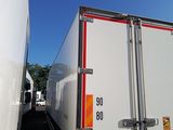 a white truck with a red stripe parked next to a white truck