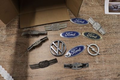 a cardboard box with a bunch of car emblems on it