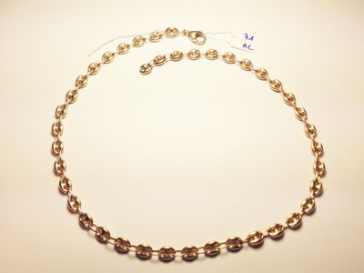 a close up of a gold necklace with a chain around it