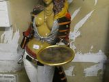 a statue of a woman holding a tray of food