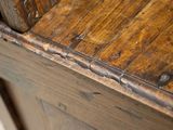 a close up view of a wooden table with a clock on it
