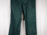 the green pants are hanging on a hanger on a white curtain
