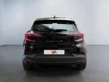 the rear end of a black car in a white room