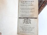 an old book that is open on a table