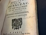 an old book that is open on a table