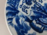 a blue and white plate with a bird on it